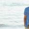 Man in casual dress on beach | Best fabrics for summer holidays | The Sharp Gentleman